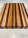 Handmade mixed wood cutting boards with antique handles